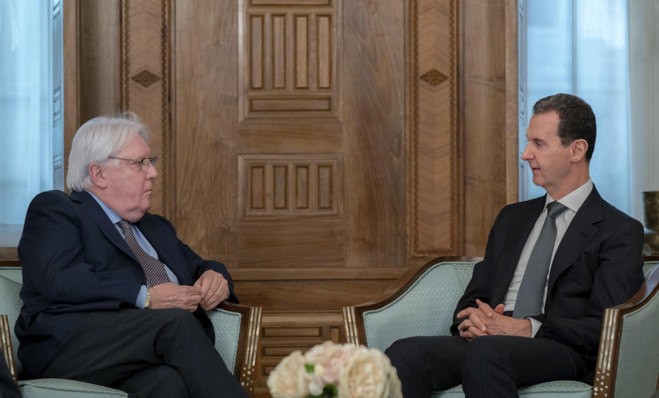 In this photo released on the official Facebook page of the Syrian Presidency, Syrian President Bashar Assad meets with Martin Griffiths, United Nations Under-Secretary-General for Humanitarian Affairs, left, in Damascus, Syria, Monday, Feb. 13, 2023. Griffiths also met with Syrian Foreign Minister Faisal Mekdad Monday to discuss ways to get aid to all parts of Syria following the deadly earthquake that hit Turkey and Syria last week. (Syrian Presidency Facebook page via AP)