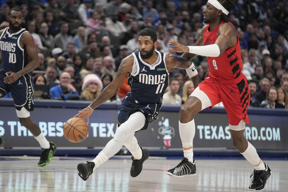 Dallas Mavericks guard Kyrie Irving (11) drives against Portland Trail Blazers forward Jerami Grant (9) during the first half of an NBA basketball game in Dallas, Wednesday, Jan. 3, 2024. (AP Photo/LM Otero)