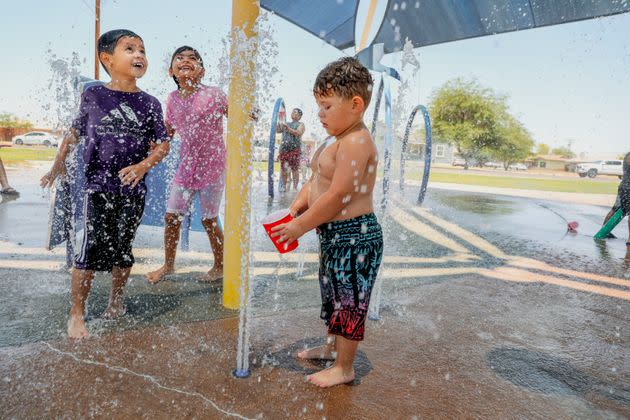 Kids play at a water park as the temperature reaches 115 degrees on June 12, 2022, in Imperial, California. (Photo: Sandy Huffaker via Getty Images)