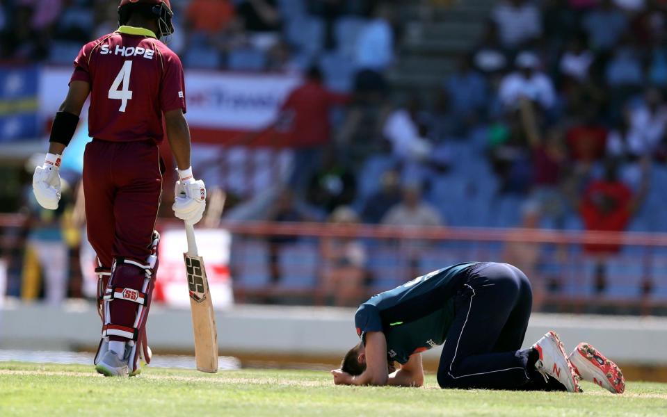 Mark Wood collapses to the floor in frustration - AP