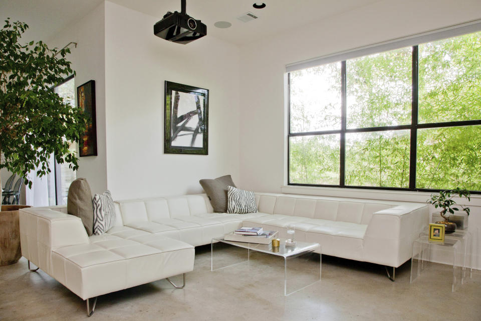 This undated photo provided by Houzz shows a room in a home with a variety of acrylic tables, including a coffee table and end tables. (Houzz via AP)