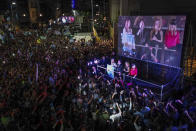 Presidential candidate of the Liberty Advances coalition Javier Milei speaks to supporters outside his campaign headquarters after winning the runoff election in Buenos Aires, Argentina, Sunday, Nov. 19, 2023. At left is his running mate Victoria Villarruel, second from right his girlfriend Fatima Florez and at right his sister Karina Milei. (AP Photo/Matias Delacroix)