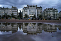 A man wearing a mask walks in the street in the center of Lyon, central France, Wednesday, Oct. 28, 2020. France is bracing for a potential new lockdown as the president prepares a televised address Wednesday aimed at stopping a fast-rising tide of virus patients filling French hospitals and a growing daily death toll. French markets opened lower on expectations that President Emmanuel Macron will announce some kind of lockdown Wednesday. (AP Photo/Laurent Cipriani)