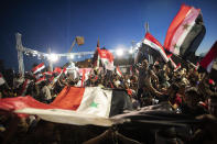 Syrian President Bashar Assad supporters hold up national flags and pictures of Assad as they celebrate at Omayyad Square, in Damascus, Syria, Thursday, May 27, 2021. (AP Photo/Hassan Ammar)