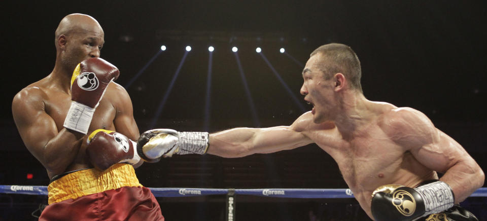 Beibut Shumenov right, of Kazakhstan, punches Bernard Hopkins, of the United States, during the third round of their IBF, WBA and IBA Light Heavyweight World Championship unification boxing match, Saturday, April 19, 2014, in Washington. Hopkins won by a split decision. (AP Photo/Luis M. Alvarez)
