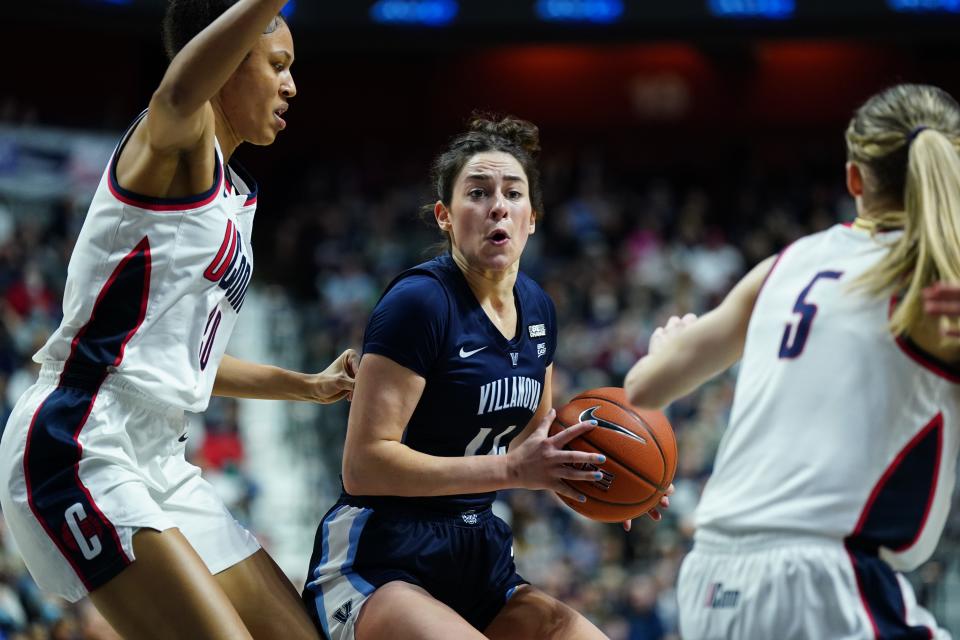 Villanova Wildcats forward Brianna Herlihy (14) works the ball against UConn Huskies guard Paige Bueckers (5) and forward Olivia Nelson-Ododa (20) in the first half of the Big East Conference Tournament Championship at Mohegan Sun Arena in Uncasville, Connecticut, on March 7, 2022.