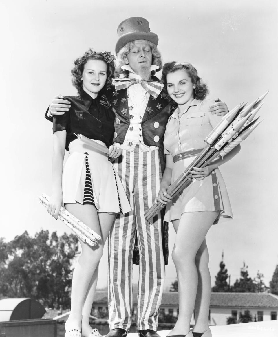 <p>Costumed actors promote Fourth of July celebrations as they pose with fireworks, Chicago, circa 1940. (Photo: Transcendental Graphics/Getty Images) </p>
