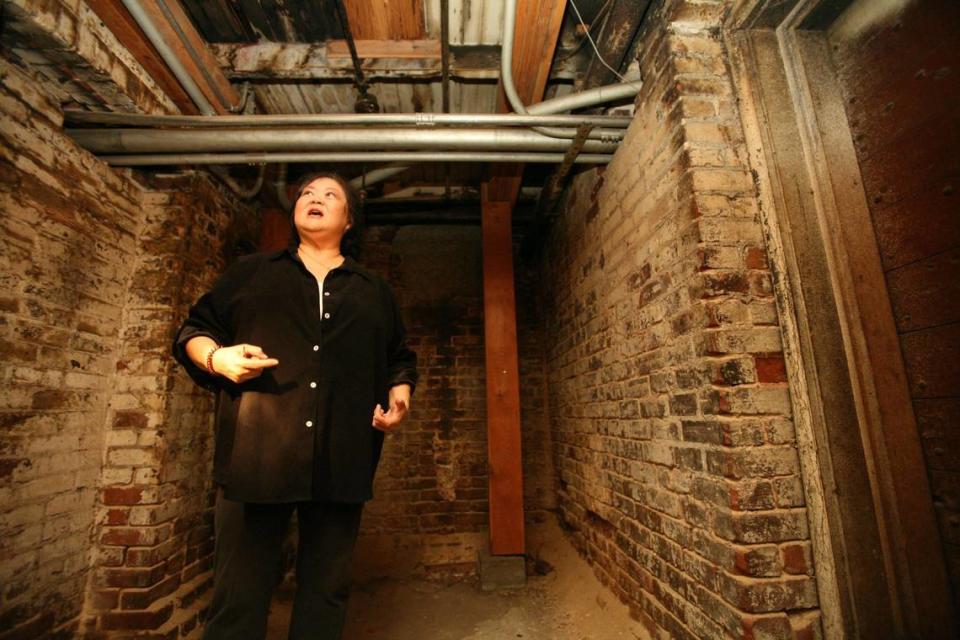 Kathy Omachi, of the nonprofit Chinatown Revitalization Inc. walks in an interconnected basement under a block in Chinatown in this file photo from 2007. Tours of basements and tunnels under Chinatown will resume in early 2024.