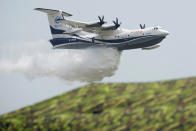 An AG600 drops a payload of water during a performance for the 13th China International Aviation and Aerospace Exhibition, also known as Airshow China 2021, on Tuesday, Sept. 28, 2021 in Zhuhai in southern China's Guangdong province. (AP Photo/Ng Han Guan)