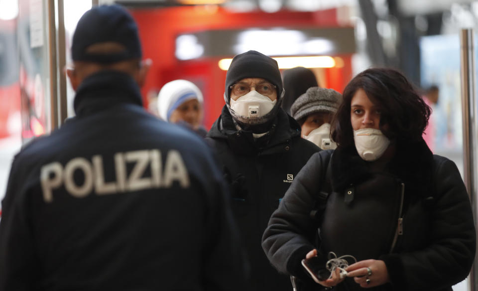 Police officers and soldiers check passengers leaving from Milan main train station, Italy, Monday, March 9, 2020. Italy took a page from China's playbook Sunday, attempting to lock down 16 million people — more than a quarter of its population — for nearly a month to halt the relentless march of the new coronavirus across Europe. Italian Premier Giuseppe Conte signed a quarantine decree early Sunday for the country's prosperous north. Areas under lockdown include Milan, Italy's financial hub and the main city in Lombardy, and Venice, the main city in the neighboring Veneto region. (AP Photo/Antonio Calanni)