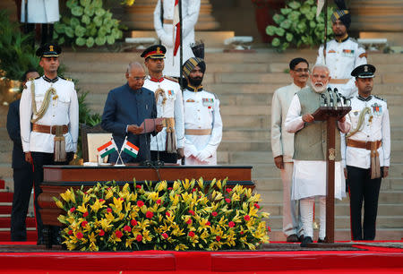 India's President Ram Nath Kovind administers oath of India's Prime Minister Narendra Modi during a swearing-in ceremony at the presidential palace in New Delhi, India May 30, 2019. REUTERS/Adnan Abidi