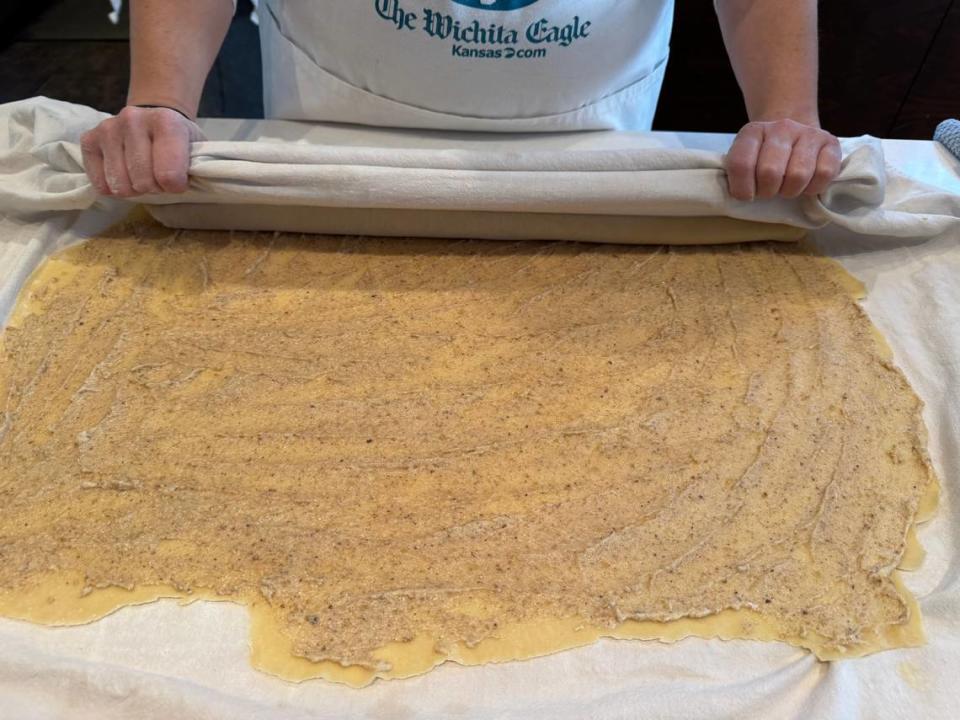Katie Grover rolls out the dough for her povitica on a giant flour-sack towel passed down to her by her grandmother. She then uses the towel to help her roll up the filled dough.