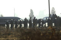 Armed riot police gather at a check point ahead of a planned protest in Harare, Friday, Aug. 16, 2019. Zimbabwe's police patrolled the streets of the capital Friday morning while many residents stayed home fearing violence from an anti-government demonstration planned by the opposition. (AP Photo/Tsvangirayi Mukwazhi)