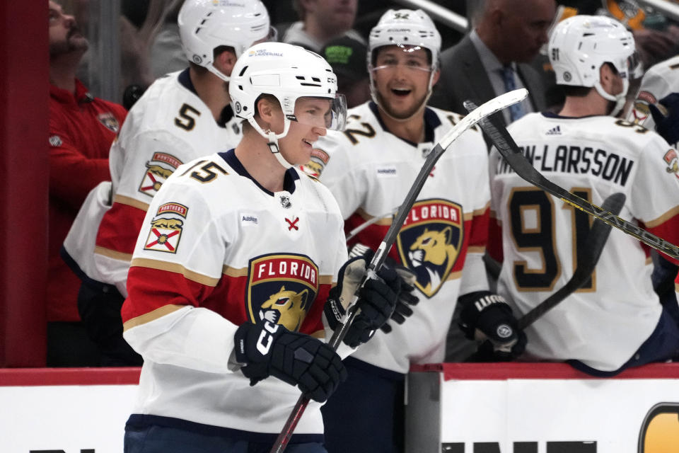 Florida Panthers' Anton Lundell (15) celebrates as he returns to the bench after scoring during the second period of an NHL hockey game against the Pittsburgh Penguins in Pittsburgh, Wednesday, Feb. 14, 2024. (AP Photo/Gene J. Puskar)