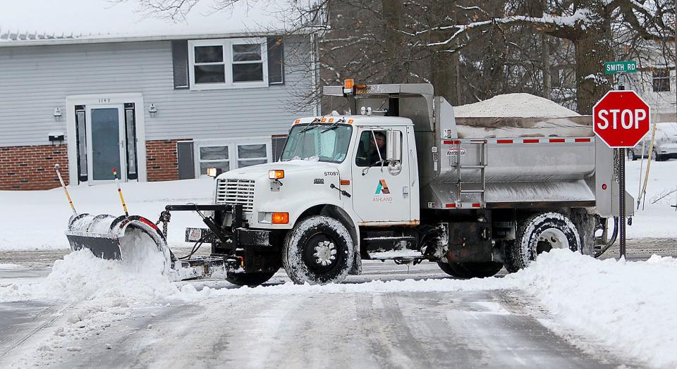 A City of Ashland snow plow clears the snow at the intersection of Crestview Drive and Smith Road on Monday.