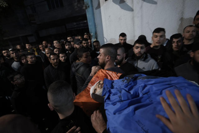 Palestinians carry the body of a man who was killed during an Israeli military raid in the West Bank city of Jenin, Tuesday, March 7, 2023. The Israeli army raided the occupied West Bank city of Jenin, leading to a gunbattle that killed at least six Palestinians. The Israeli military said it killed the assailant who was behind the fatal shooting of Israeli brothers in a West Bank town last week. (AP Photo/Majdi Mohammed)