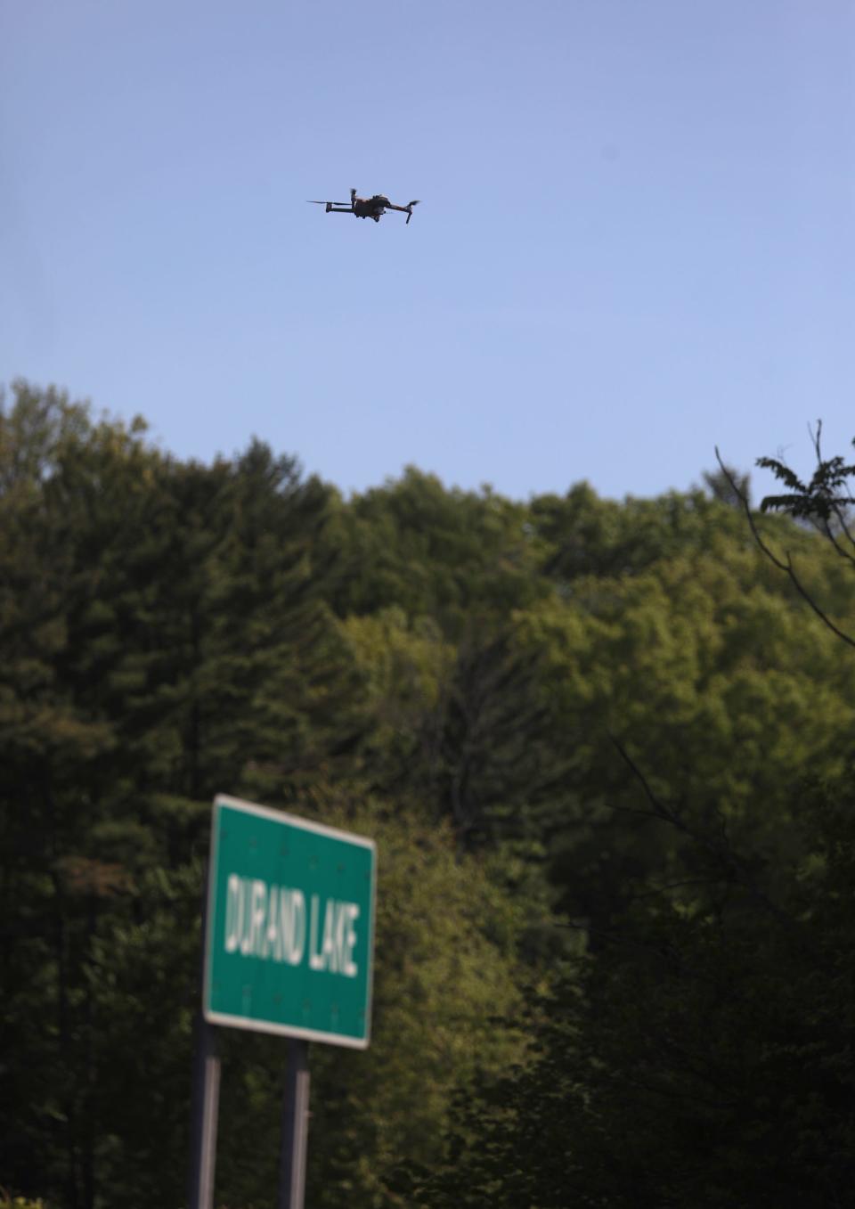 Irondequoit Police, Monroe County Sheriff's Office and New York State Police investigate Durand Lake, where human remains were found in 2021. A drone was flown over an area close to the road.