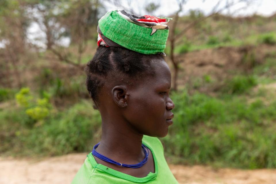 Lina Lokol, 30, getting ready to carry a 20 litre jerrycan full of water back home from River Nataa, Ariamaoi village, Nabiratuk District, Karamoja region, Uganda (WaterAid/James Kiyimba)