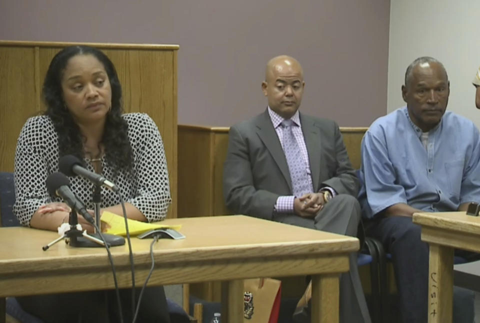 <p>Arnelle Simpson, left, testifies for her father, former NFL football star O.J. Simpson, far right, as attorney, Malcolm LaVergne, center, listens during O.J. Simpson’s hearing at the Lovelock Correctional Center in Lovelock, Nev., on Thursday, July 20, 2017. Simpson was convicted in 2008 of enlisting some men he barely knew, including two who had guns, to retrieve from two sports collectibles sellers some items that Simpson said were stolen from him a decade earlier. (KOLO-TV via AP, POOL) </p>