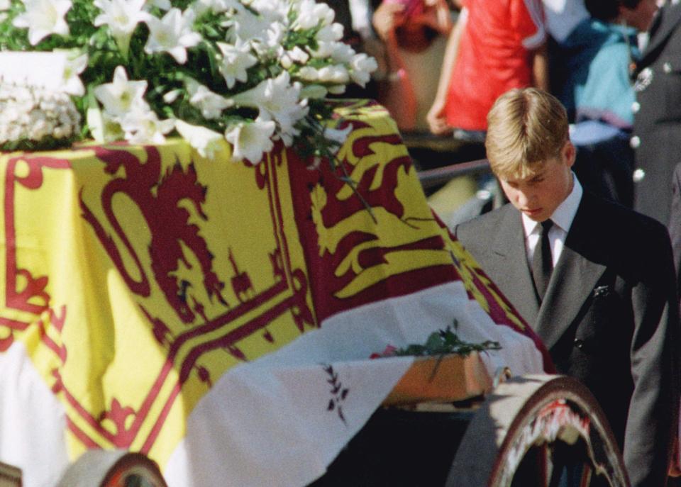 FILE - Prince William walks with his head bowed behind the coffin of his mother Diana, Princess of Wales draped in the Royal Standard, en route to London's Westminster Abbey for her funeral ceremony, Saturday, Sept. 6, 1997. Now Prince William looks and sounds good, standing tall as he prepares for married life. But it is possible that the future king's easy self-assurance and quality tailoring masks some damage caused by his parent's failed marriage and his mother's death. (AP Photo/Ulli Michel, Pool, File)