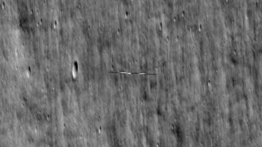 A dark streak over the moon as seen by a NASA spacecraft.