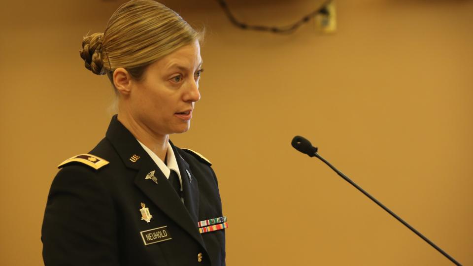 Maj. Kari Beth Neuhold, of the Kansas National Guard, testifies before a legislative committee.