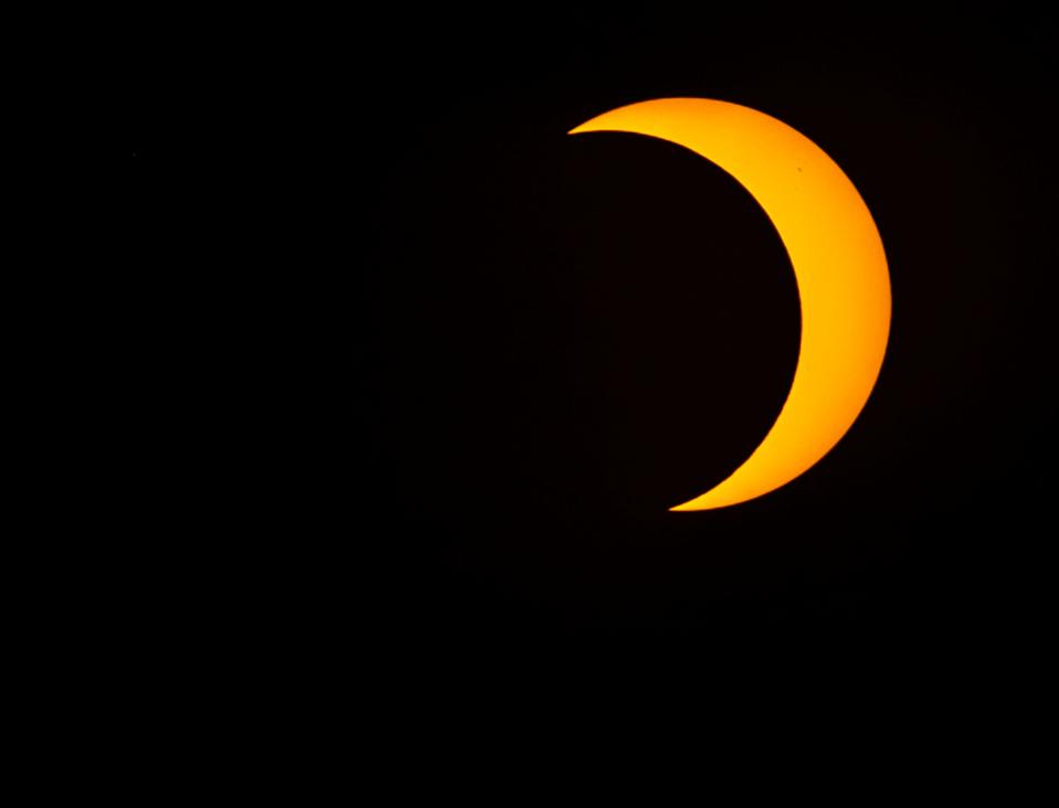 A near-peak view of the solar eclipse is seen from Rancho Mirage Community Park on Saturday. The peak viewing of the event in the area was at 9:26 a.m., with the moon blocking 73% of the sun's disk.