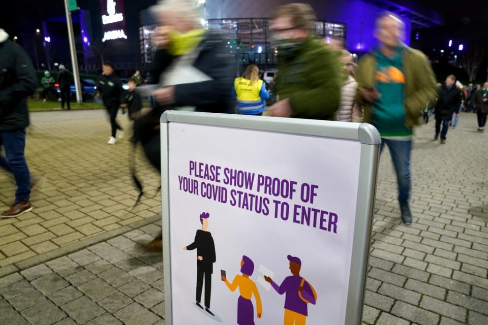 Celtic fans show Covid passes upon entry before the Premiership match at Celtic Park, Glasgow (Andrew Milligan/PA) (PA Wire)