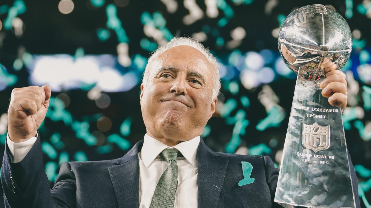 Philadelphia Eagles owner Jeffrey Lurie holds up the Vince Lombardi Trophy after the NFL Super Bowl 52 football game against the New England Patriots, in Minneapolis.