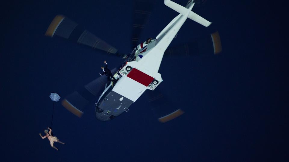 Performers depicting Queen Elizabeth and James Bond parachute from a helicopter during the opening ceremony for the 2012 London Olympics on Friday, July 27, 2012