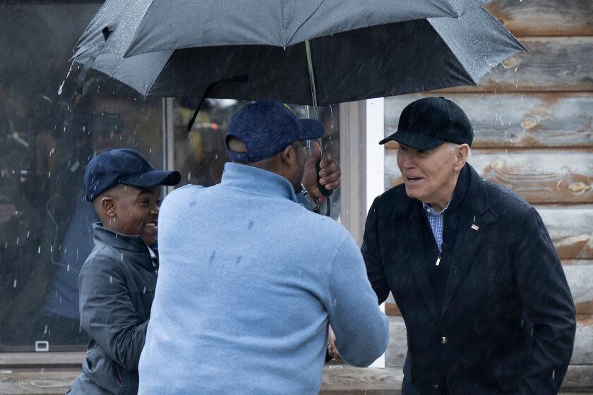 US President Joe Biden is greeted by Hurley Coleman III and Hurley Coleman IV while arriving for a campaign event with supporters at Pleasant View Golf Course in Saginaw, Michigan, on March 14, 2024, (Photo by Brendan Smialowski / AFP) (Photo by BRENDAN SMIALOWSKI/AFP via Getty Images)
