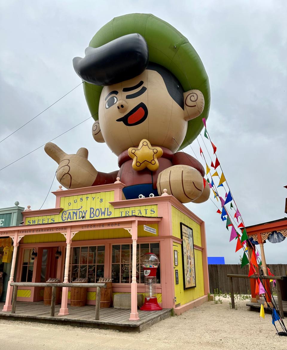 giant inflatable cowboy figure above a western-style restaurant front