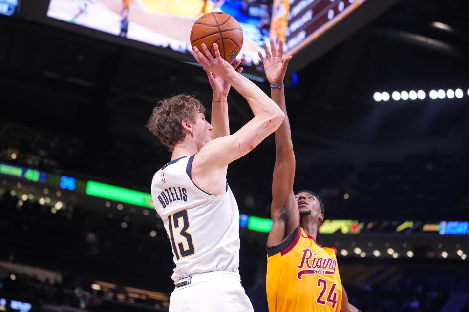 Matas Buzelis, left, of the G League Ignite, shoots the winning basket over Brandon Miller, right, of the Charlotte Hornets, during an NBA Rising Stars basketball game in Indianapolis, Friday, Feb. 16, 2024. (AP Photo/Michael Conroy)