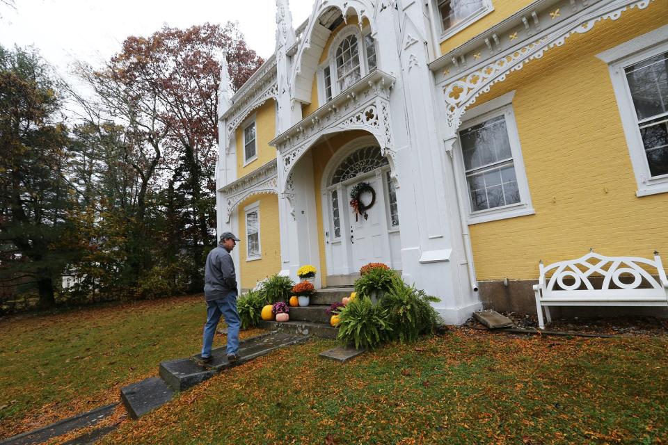 Hunt Edwards, who owns the Wedding Cake House in Kennebunk, Maine, is seen here at the historic home in October 2023. Edwards and his wife, Katie, are seeking a contract zone that would let them transform the home into an inn and venue.