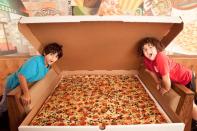 Available on the menu at Big Mama's and Papa's Pizzeri in Los Angeles, California, USA, is an enormous 1.37 m wide (4 ft 6 in) square pizza. Retailing at $199.99 (£121) plus tax, this mammoth meal can feed up to 100 people and can be ordered for delivery – as long as you give the pizzeria 24 hours' notice!