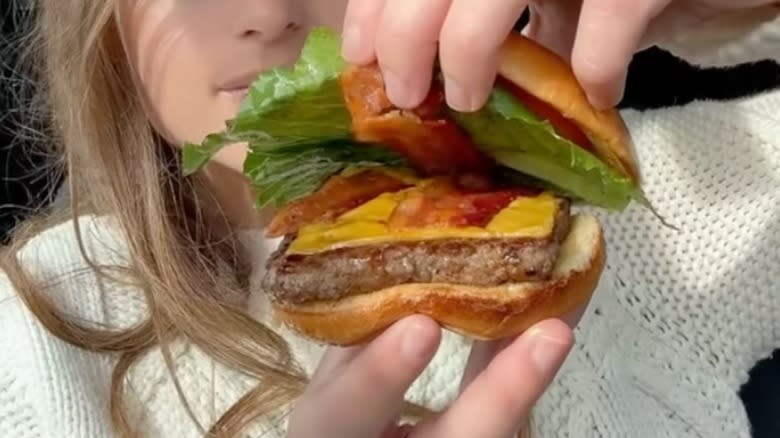 Hand holding Wendy's burger open