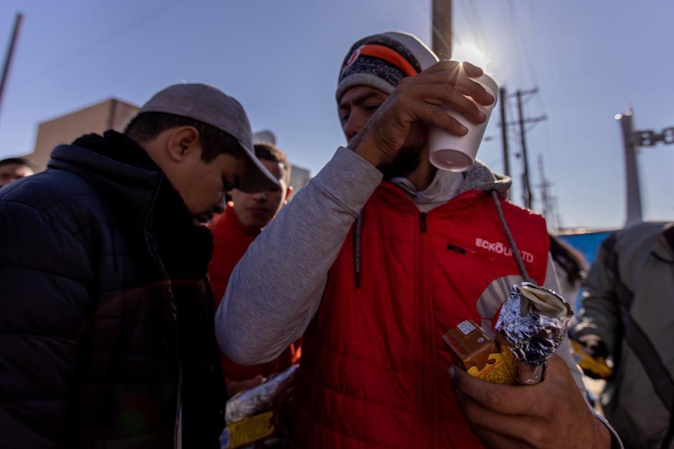 Mi Cabaña Mexican Restaurant brings juice, water, hot chocolate and burritos to Venezuelan migrants staying in the streets of El Paso in front of Sacred Heart Church, on Wednesday, Dec. 21, 2022, after crossing into the U.S.