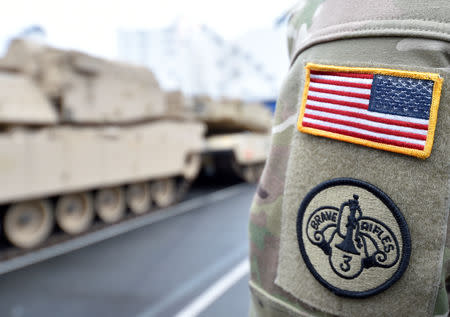 FILE PHOTO: U.S. tanks, trucks and other military equipment, which arrived by ship, are unloaded in the harbour of Bremerhaven, Germany January 8, 2017. REUTERS/Fabian Bimmer/File Photo