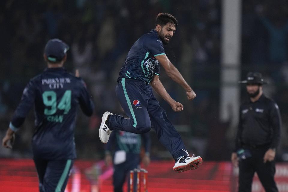 Pakistan's Harif Rauf, center, jumps to celebrate after taking the wicket of England's Olly Stone during the fourth twenty20 cricket match between Pakistan and England, in Karachi, Pakistan, Sunday, Sept. 25, 2022. (AP Photo/Anjum Naveed)