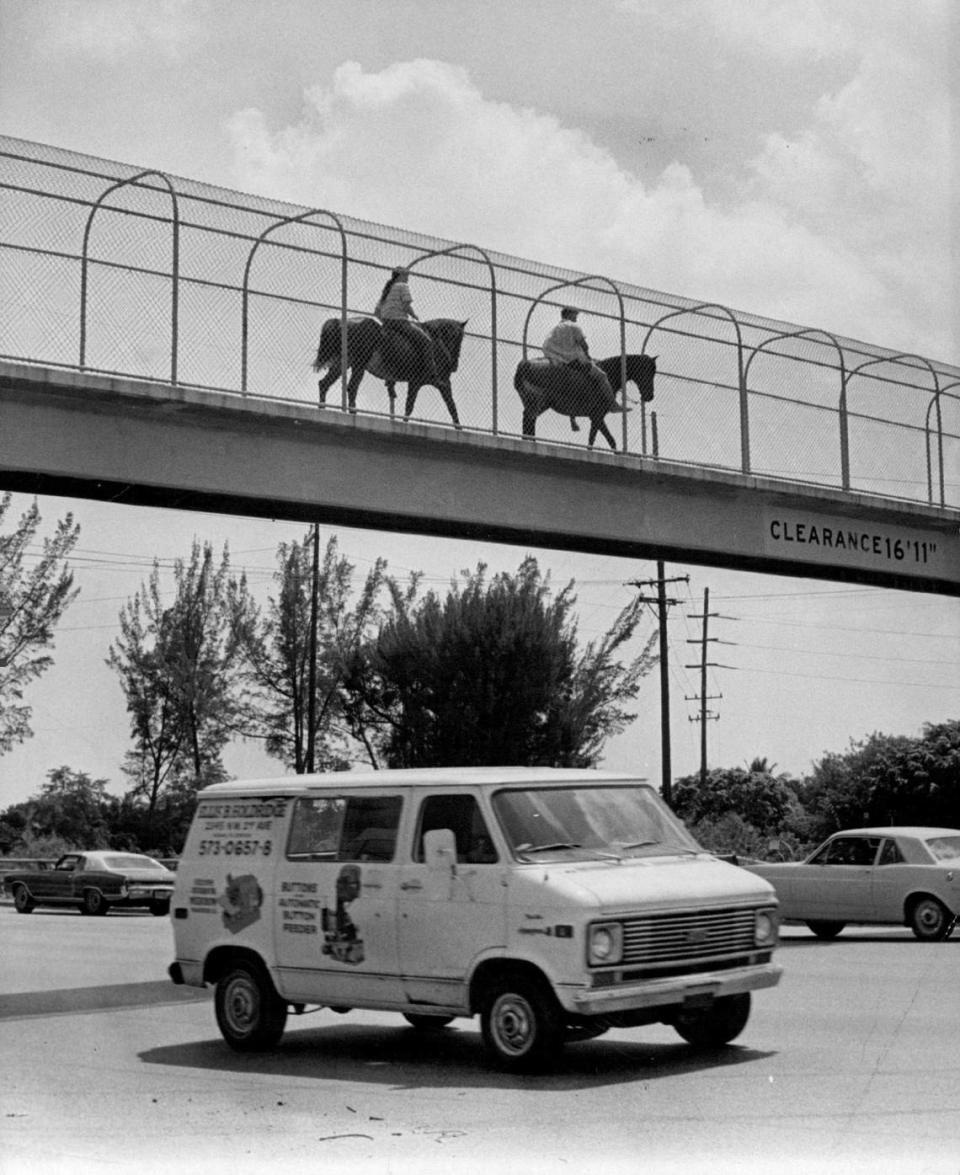 Two horseback riders cross Okeechobee Road and Fourth Avenue in Hialeah.