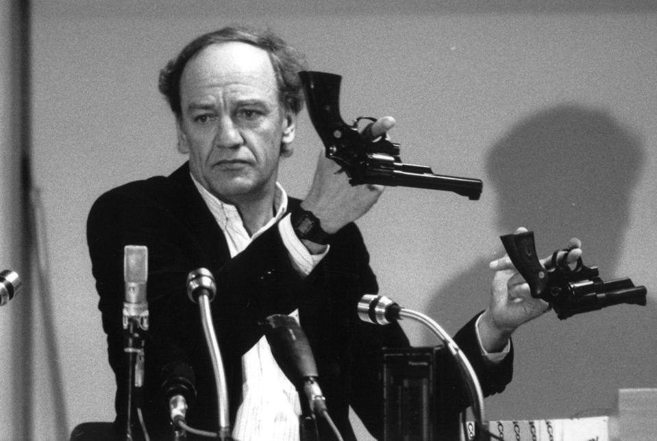 FILE - In this March 31, 1986 file photo Hans Holmer, former head of the investigation into the assassination of Swedish Prime Minister Olof Palme, shows two Smith & Wesson .357 Magnum revolvers during a press conference in Stockholm. Swedish prosecutors will announce Wednesday June 10, 2020 a decision in the investigation into the long unsolved murder of former Swedish Prime Minister Olof Palme, who was shot dead in downtown Stockholm in 1986. (Håkan Rodén/TT via AP, File)