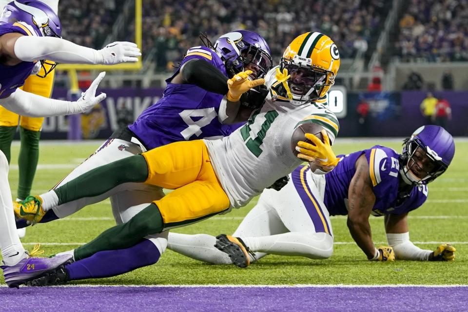 Green Bay Packers' Jayden Reed stretches to get into the end zone for a touchdown during the first half of an NFL football game against the Minnesota Vikings Sunday, Dec. 31, 2023, in Minneapolis. (AP Photo/Abbie Parr)