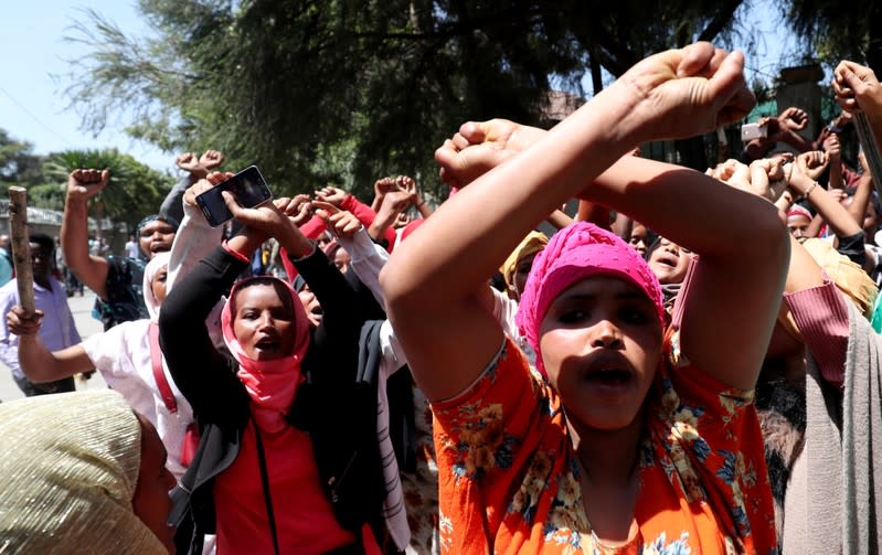 Women supporters show the Oromo protest gesture outside Jawar Mohammed's house, an Oromo activist and leader of the Oromo protest in Addis Ababa