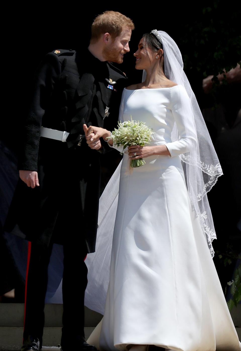 Prince Harry, Duke of Sussex and The Duchess of Sussex share a kiss after their wedding at St George's Chapel at Windsor Castle on May 19, 2018 in Windsor, England