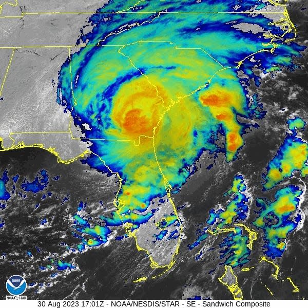 infrared satellite animation shows cyclone churning over georgia and south carolina mostly green outer bands with small red orange center