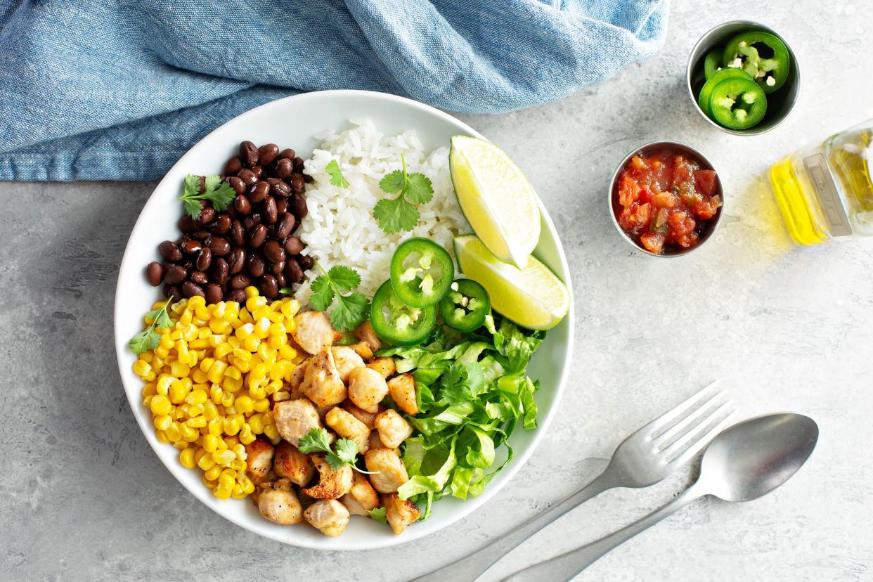 Chipotle spicy chicken lunch bowl with rice corn, beans, rice and jalapenos