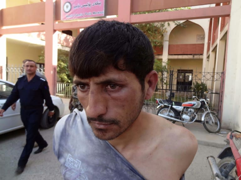 A suspected member of the Islamic State (IS) group is detained by Iraqi Kurdish forces in the southern Domiz neighbourhood of Kirkuk on October 21, 2016, after jihadist gunmen attacked the city