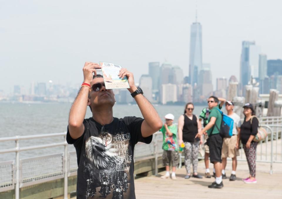 The partial solar eclipse on Aug. 21, 2017, prompted many New Yorkers and tourists to head outside to experience the rare celestial phenomenon WireImage