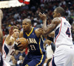 Indiana Pacers forward David West (21) drives between Atlanta Hawks guard Kyle Korver, left, and forward Paul Millsap (4) in the first half of Game 3 of an NBA basketball first-round playoff series on Thursday, April 24, 2014, in Atlanta. (AP Photo/John Bazemore)