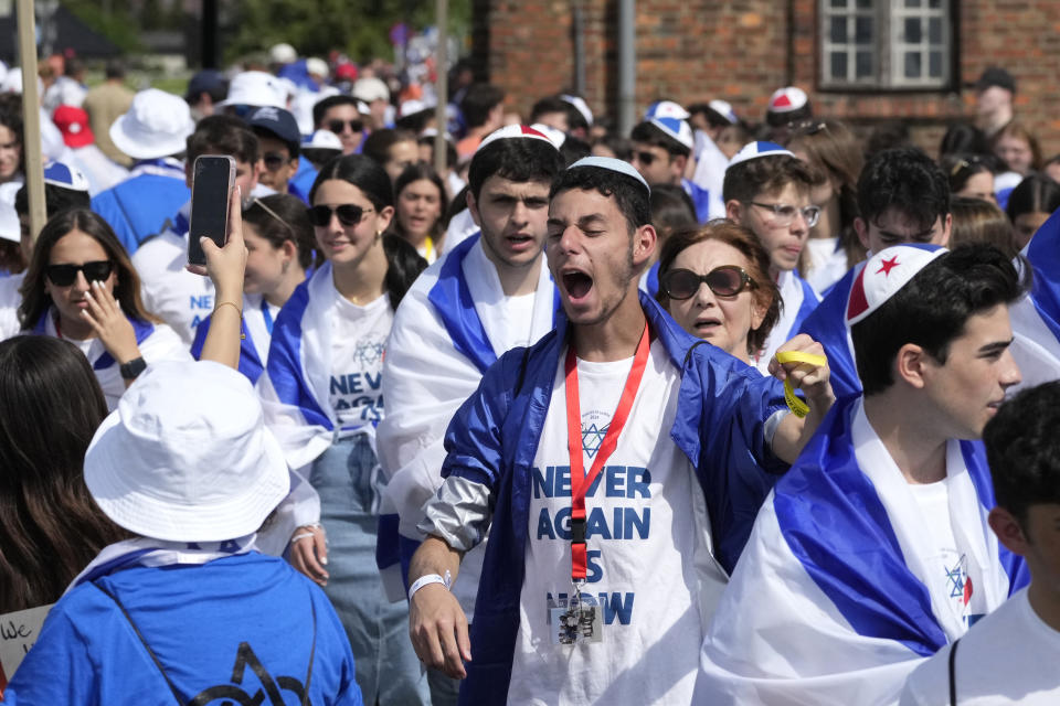 People walk through the former Nazi German death camp of Auschwitz-Birkenau as they attend the annual Holocaust remembrance event, the "March of the Living" in memory of the six million Holocaust victims in Oswiecim, Poland, Monday, May 6, 2024. The event comes amid the dramatic backdrop of the violence of the Israel-Hamas war after the Oct. 7 Hamas attack, the deadliest violence against Jews since the Holocaust, and as pro-Palestinian protests sweep U.S. campuses. (AP Photo/Czarek Sokolowski)